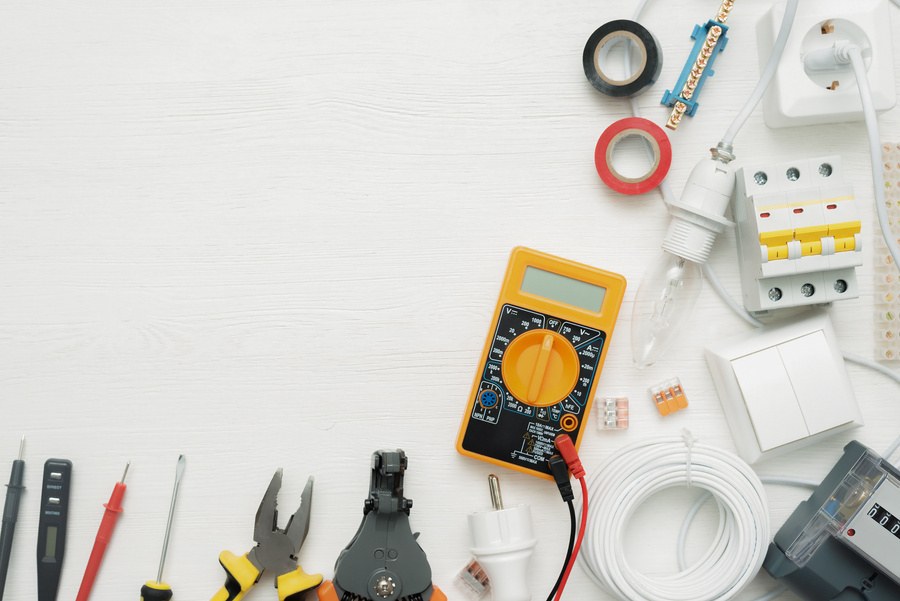 Multimeter and electrical tools on a work surface