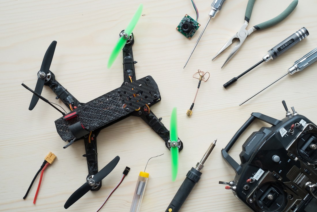 Drone kit, controller and assembly tools on a table