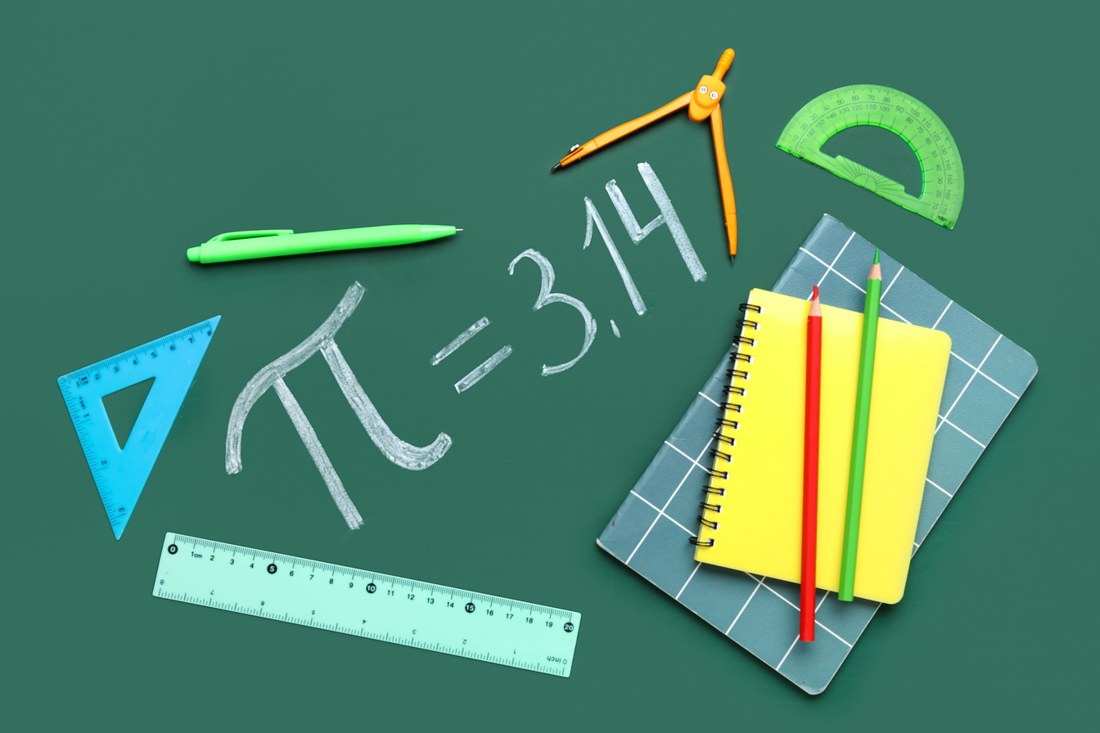 Geometry tools and mathematics materials on a green board