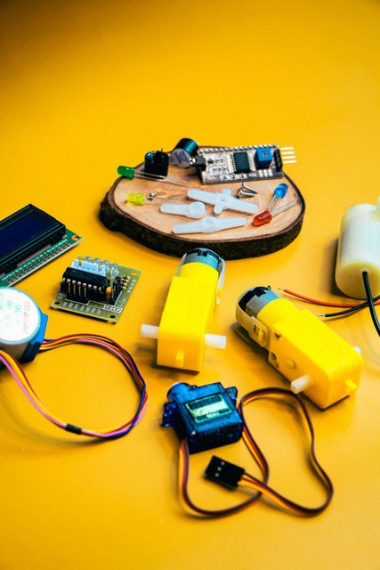 Motors, controller boards and experiment components on a yellow background