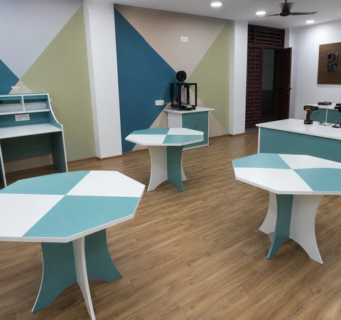 Turquoise and white geometric activity tables in a learning lab